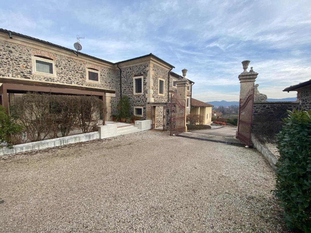 a large house with a gravel driveway in front of it at Ca' Masieri Hotel in Trissino