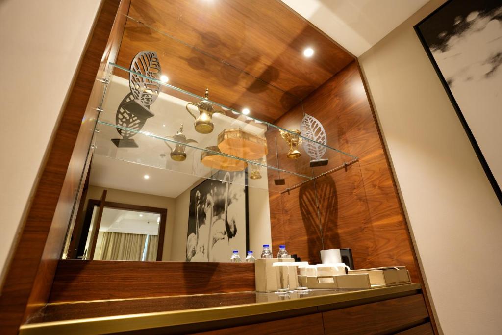 a bathroom with a mirror and a sink at Mirfa Hotel in Al Mirfa