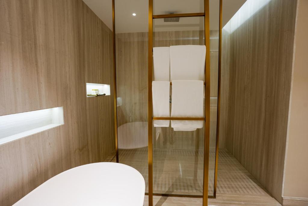 a bathroom with a glass shower and a toilet at Mirfa Hotel in Al Mirfa