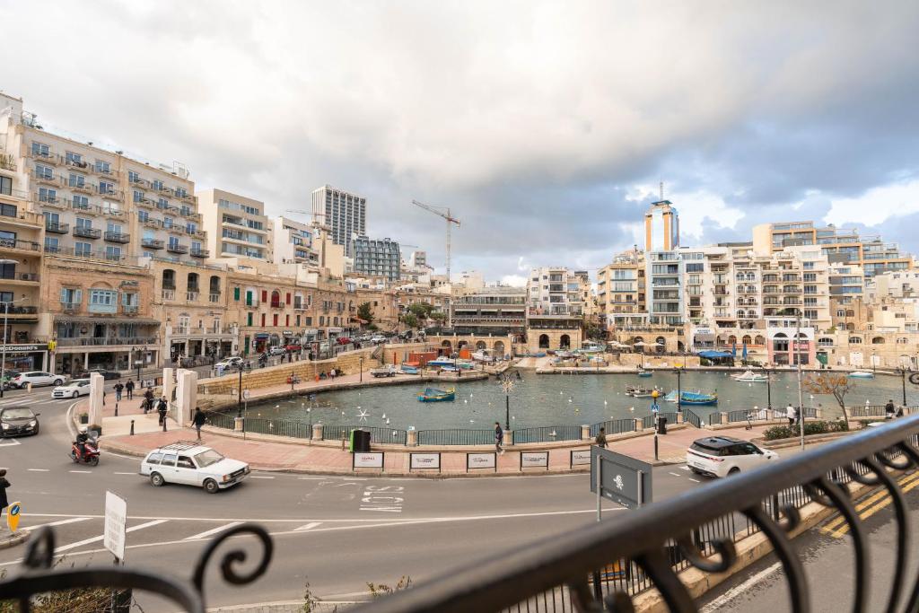 a view of a city with a river and buildings at The Rose Hostel in St. Julianʼs
