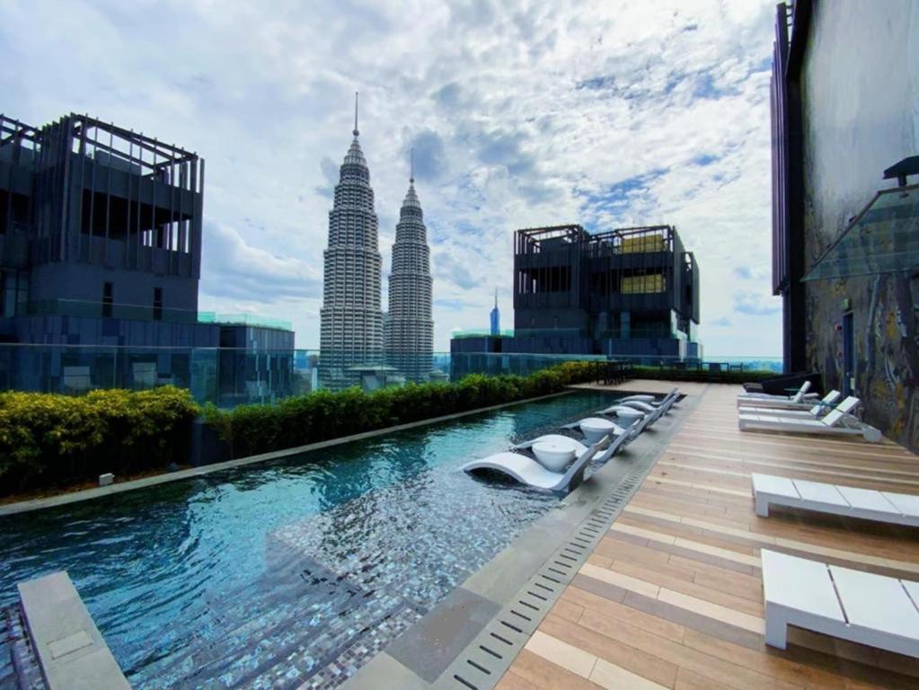 a pool on a building with a view of the city at Star KLCC By B&B in Kuala Lumpur
