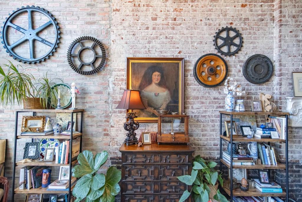 a room with a portrait of a woman on a brick wall at Elegant Downtown Memphis Loft - Walk to Beale St! in Memphis
