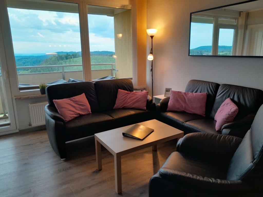 Sala de estar con 2 sofás y mesa en Apartment 574, en Braunlage