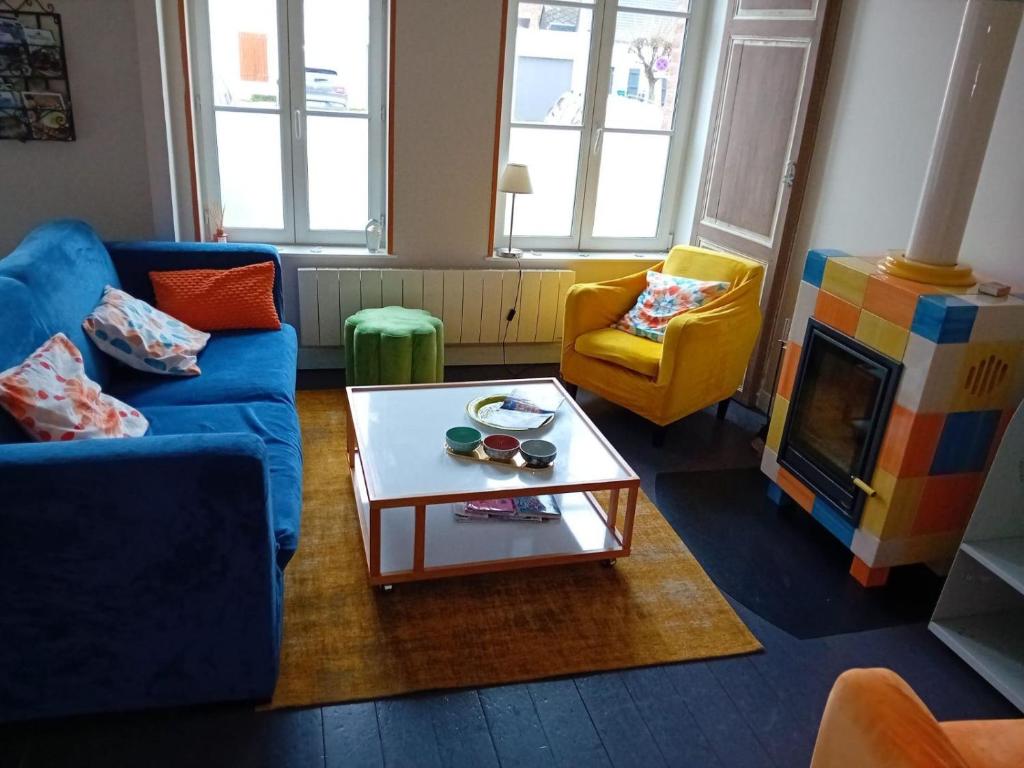 a living room with a couch and a coffee table at Maisonnette à Saint Valéry Sur Somme in Saint-Valéry-sur-Somme