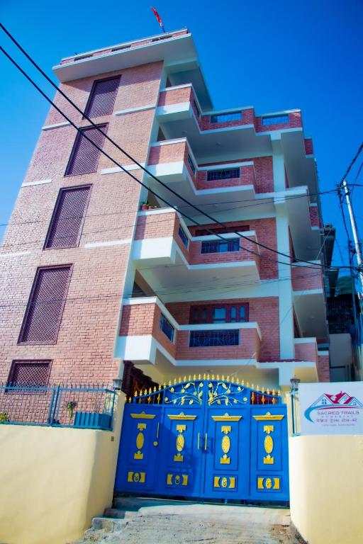 a building with blue doors in front of it at Sacred Trails Kathmandu Accommodation in Kathmandu