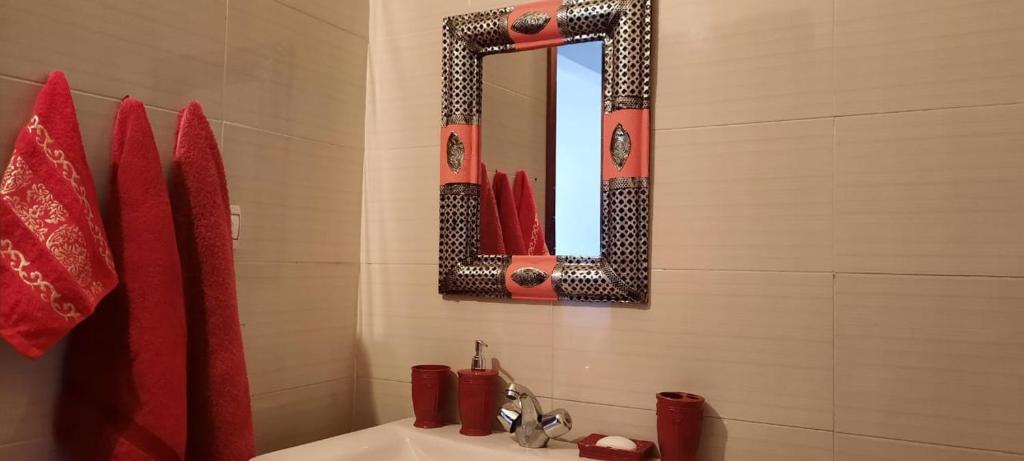 a bathroom with a sink and a mirror at Residence salam in Agadir