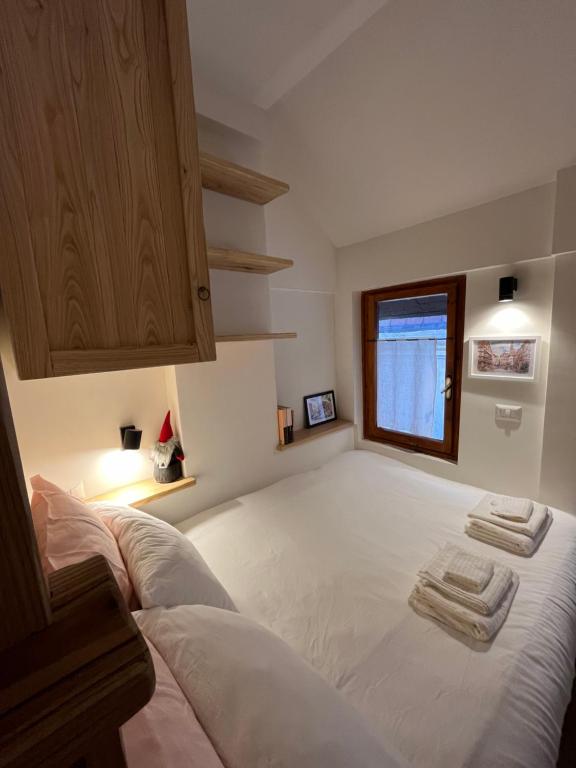 een slaapkamer met een groot bed en handdoeken bij Casa vacanza La Genziana in Roccaraso