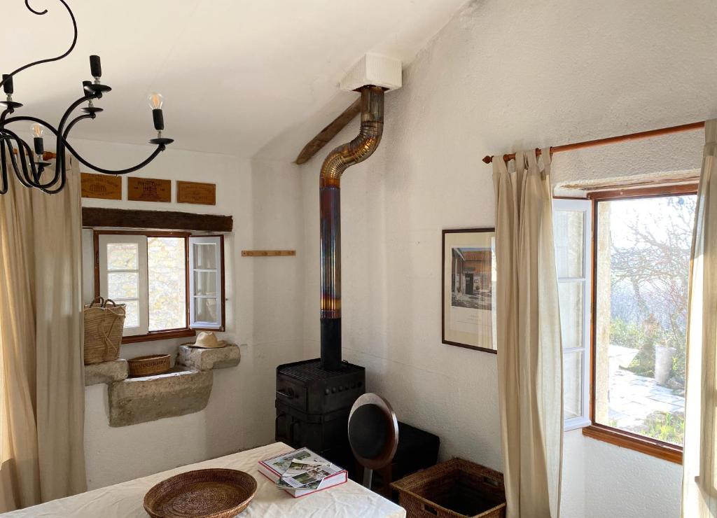 a room with a stove and a table and a window at Gîte de charme avec grand jardin &amp; piscine in Touffailles