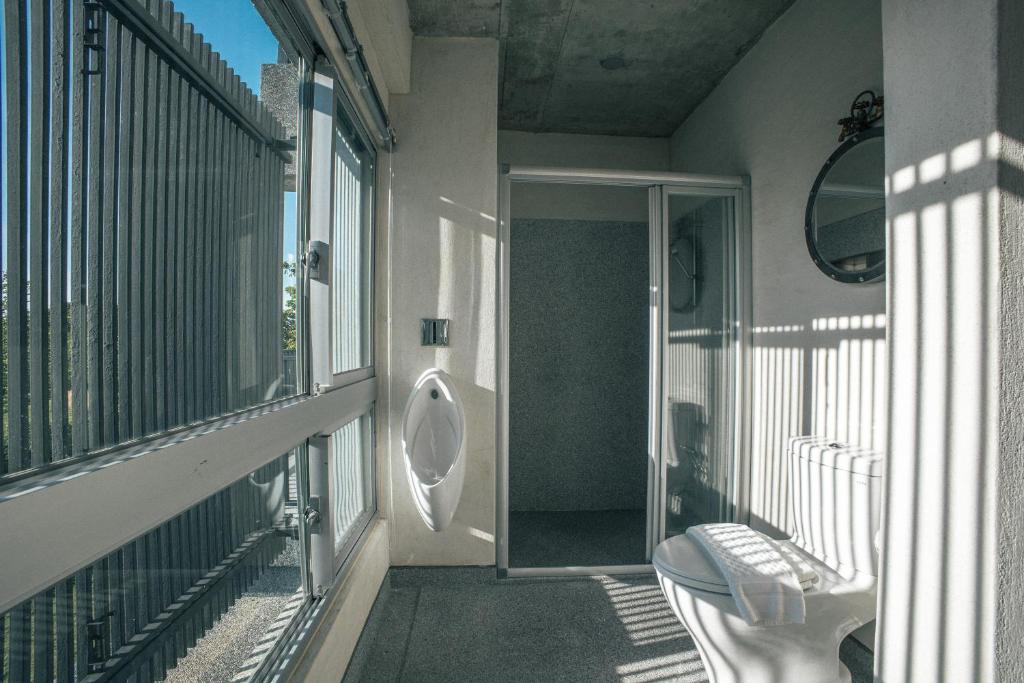 a balcony with a toilet on the side of a building at 57villa in Hengchun South Gate