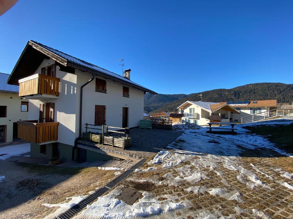 a view of a building with snow on the ground at Casetta Turati in Castelfondo