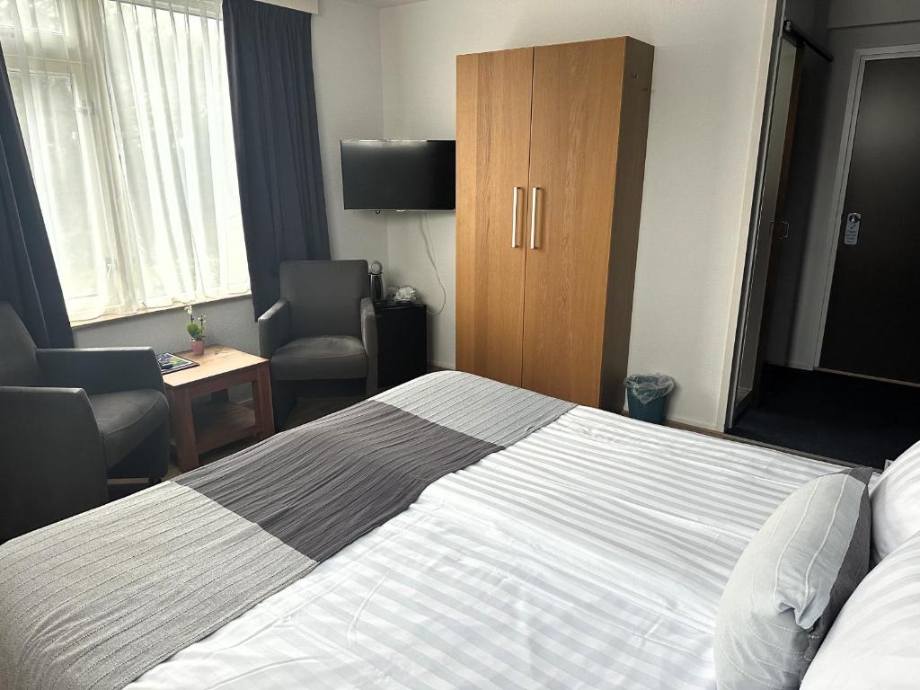 Postel nebo postele na pokoji v ubytování DuinHotel Texel