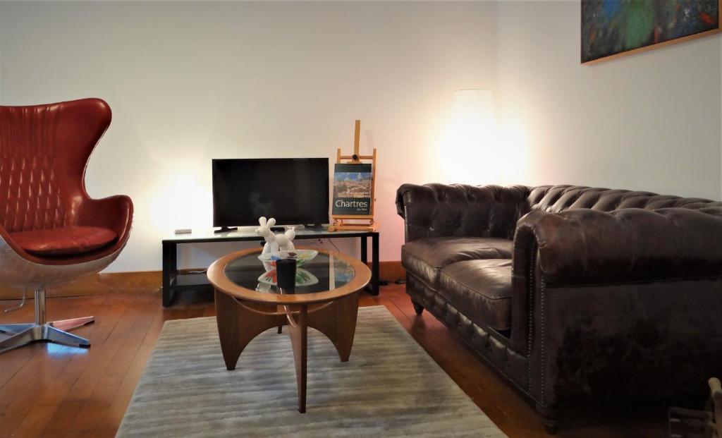 a living room with a couch and a coffee table at L'esprit d'antan, quartier historique deux personnes in Chartres