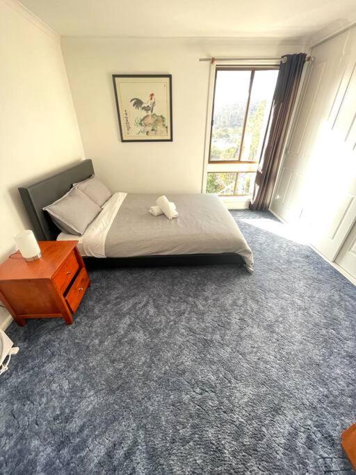 a bedroom with a bed and a table and a window at Relaxation Holiday Home in Bellerive in Bellerive