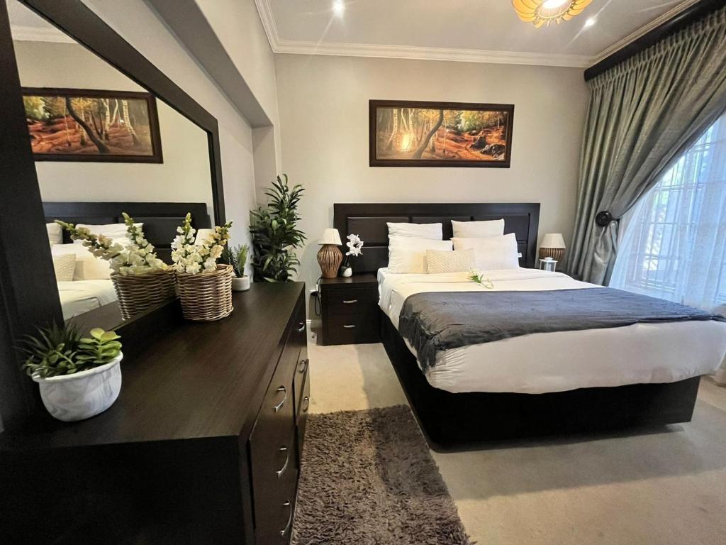 a bedroom with a large bed and a large window at 337 Justice Mahomed Guest House in Pretoria