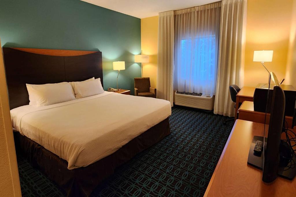 a hotel room with a large bed and a window at AmericInn by Wyndham St Cloud MN Shopping Area in Saint Cloud