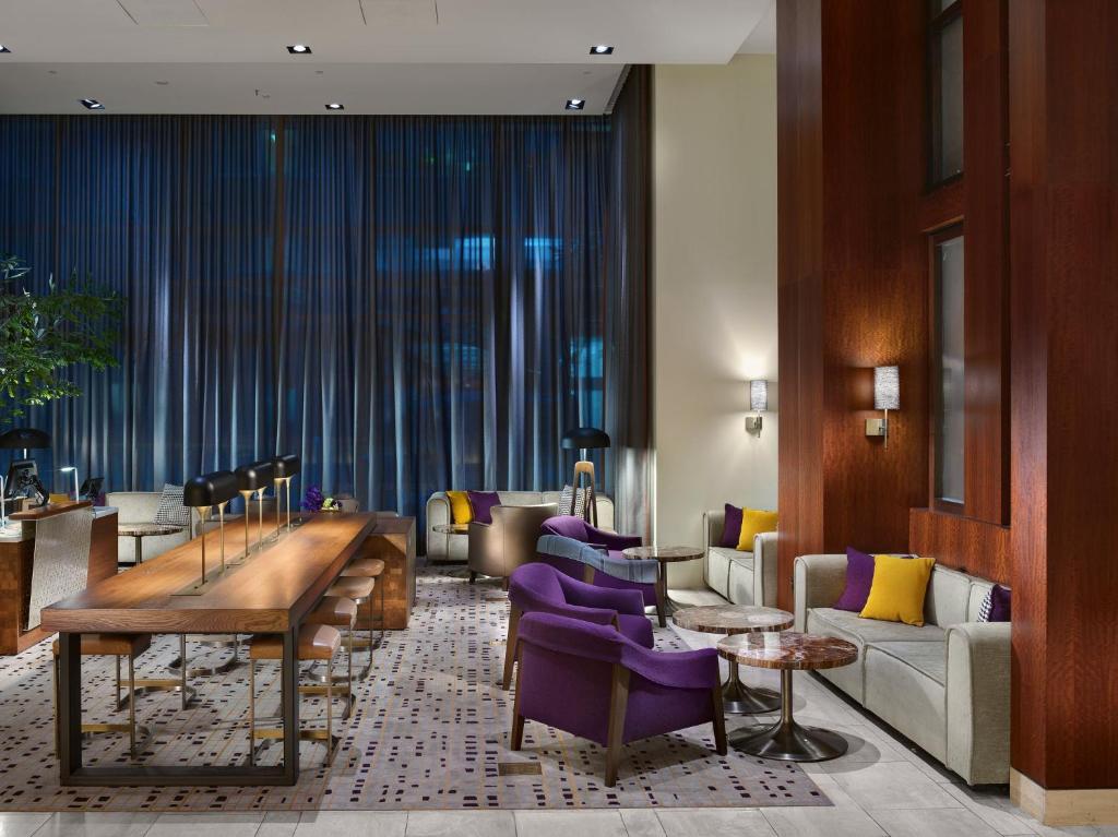 a hotel lobby with purple chairs and a table at InterContinental San Francisco, an IHG Hotel in San Francisco