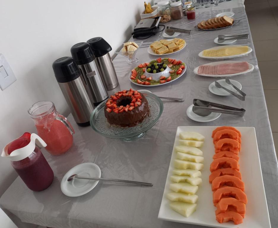 a table topped with a table with sushi and food at Escalada Hospedagens e Eventos in Mucugê