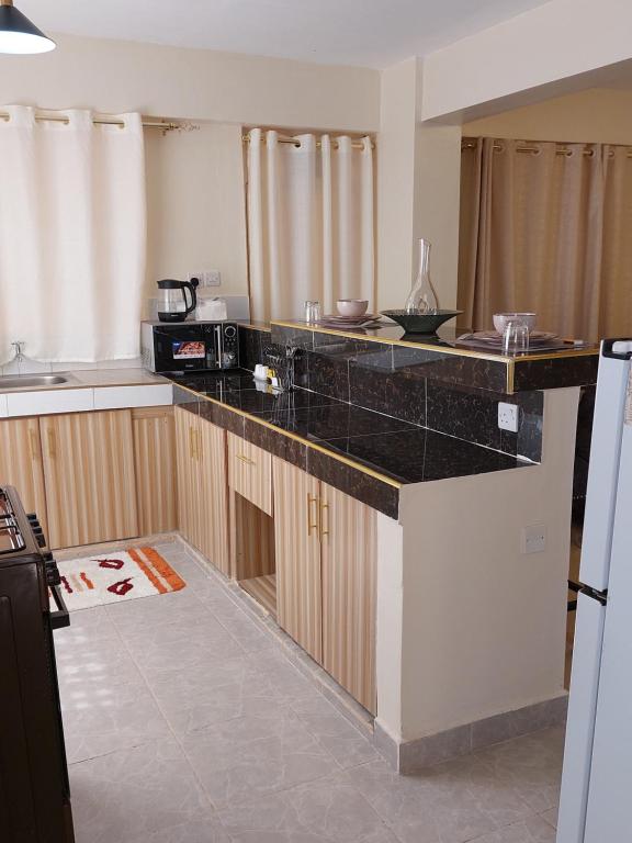 Kuchyň nebo kuchyňský kout v ubytování Rawin Homes