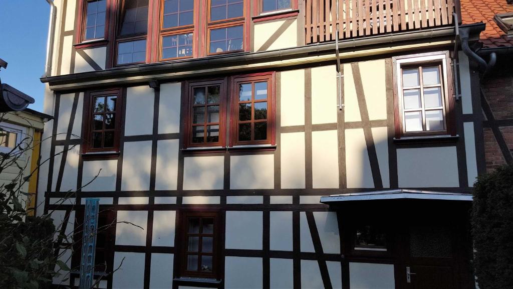 a black and white building with windows and a balcony at Fewo An der alten Stadtmauer in Blankenburg