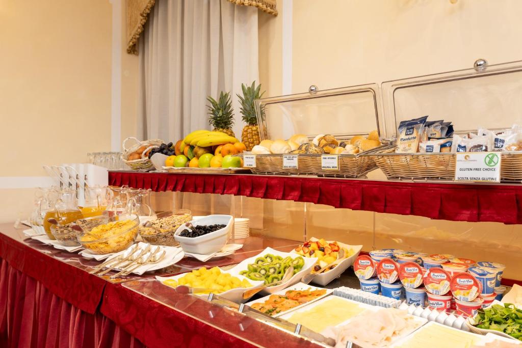 a buffet with fruit and other food on a table at Hotel A La Commedia in Venice