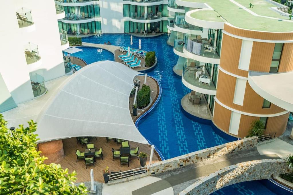 an aerial view of a swimming pool in a building at Direct pool access studio Twin Sands by Lofty in Patong Beach