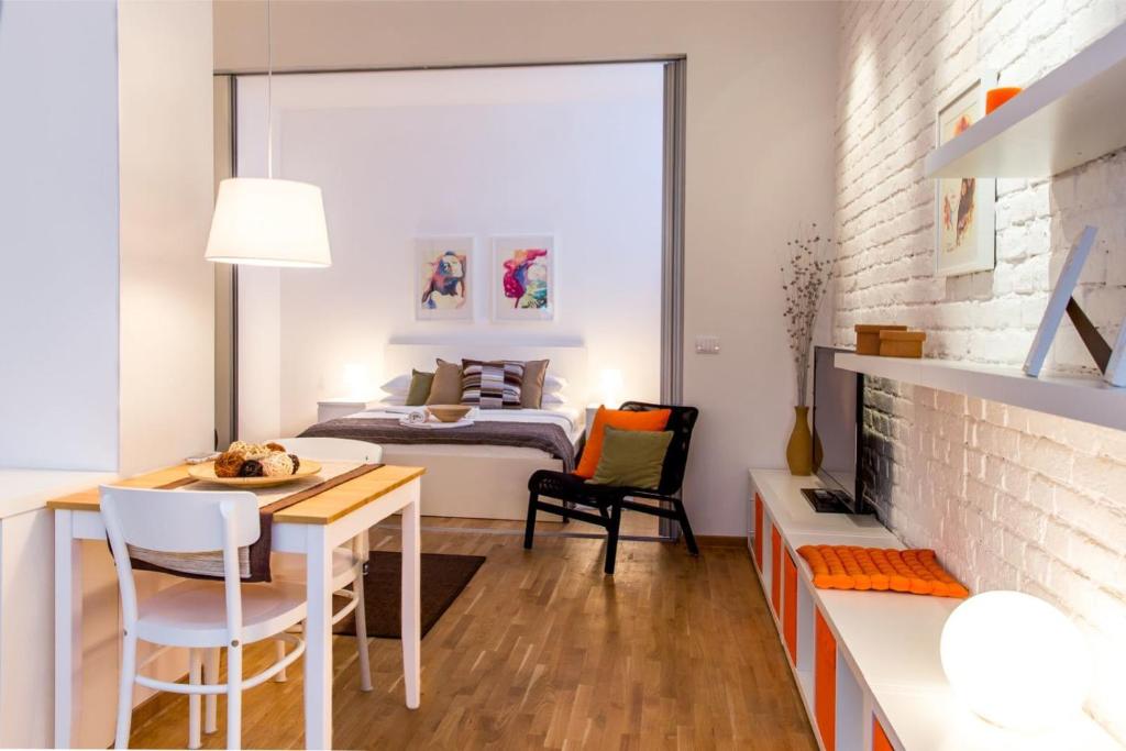 Schlafzimmer mit einem Bett, einem Tisch und Stühlen in der Unterkunft Apartments Centro in Belgrad