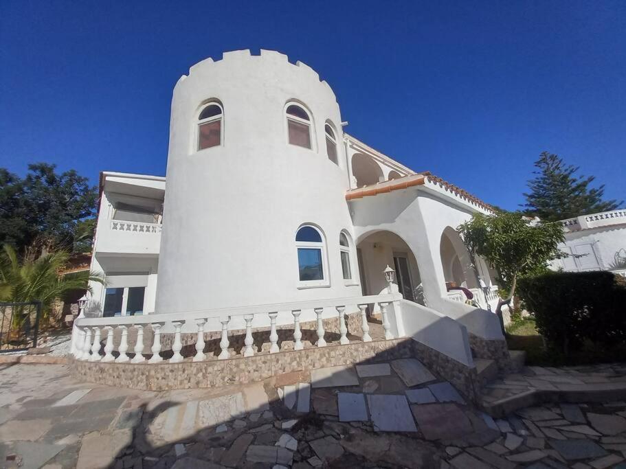 a large white house with a staircase in front of it at Apartamento Montemar I REA-MON2 in Castellón de la Plana