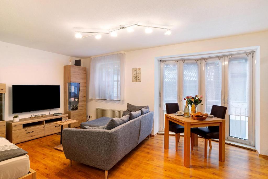 a living room with a couch and a table at Schwarzwaldnestle in Bad Wildbad