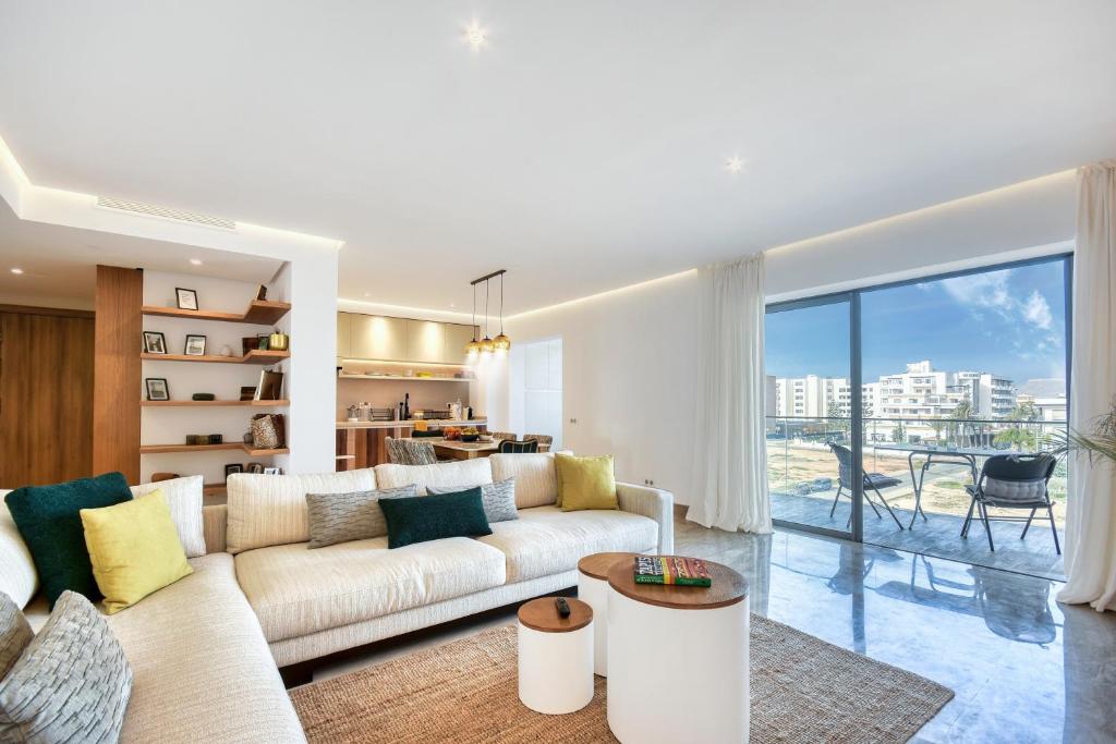 a living room with a couch and a table at Jad - Luxe - piscine - 6 Px in Agadir