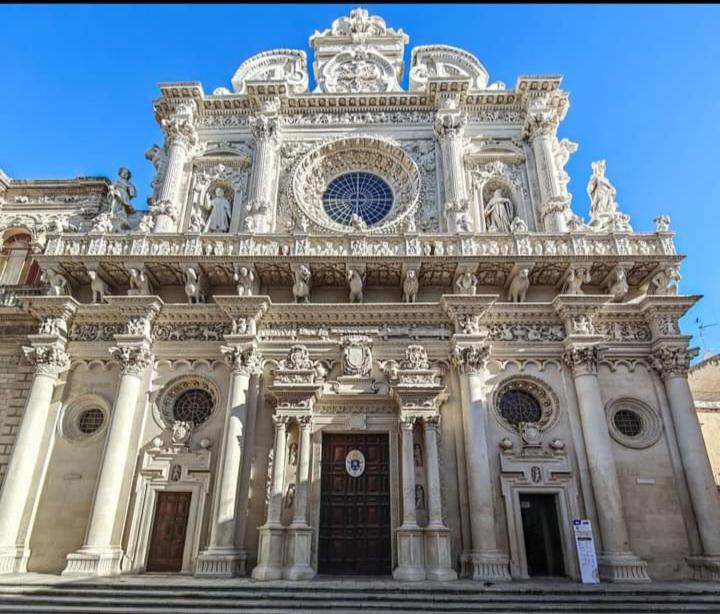 a large stone building with a clock on it at Casa Piero in Lecce