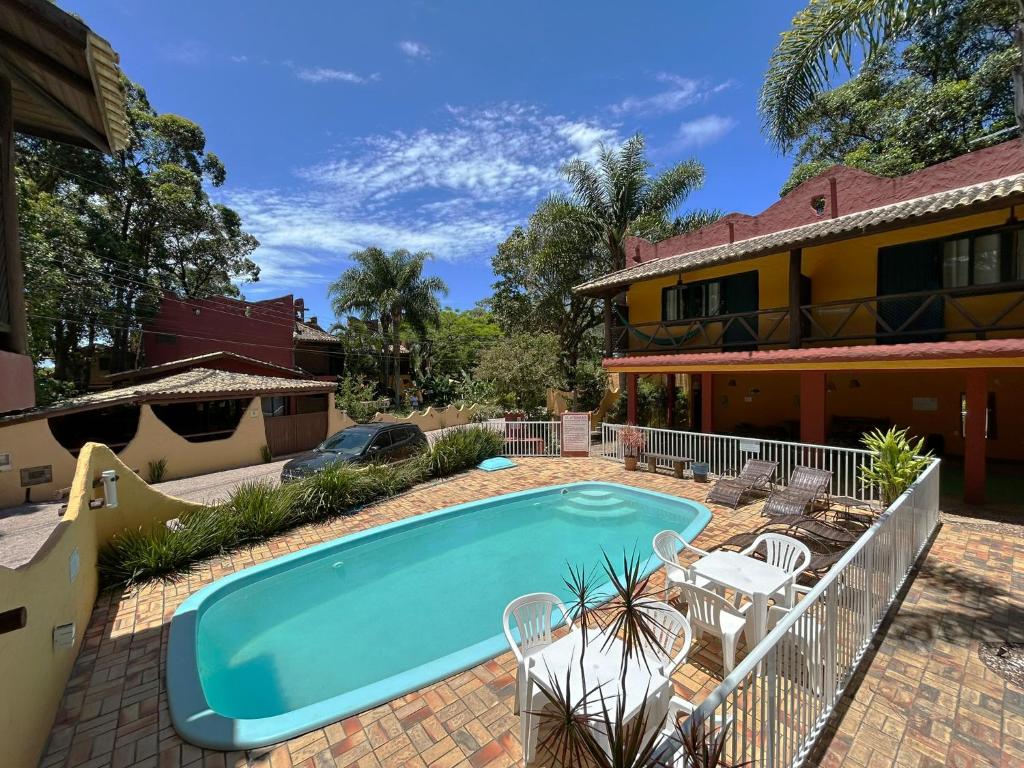 a swimming pool in the backyard of a house at Pousada Beleza Pura na Praia da Ferrugem in Garopaba
