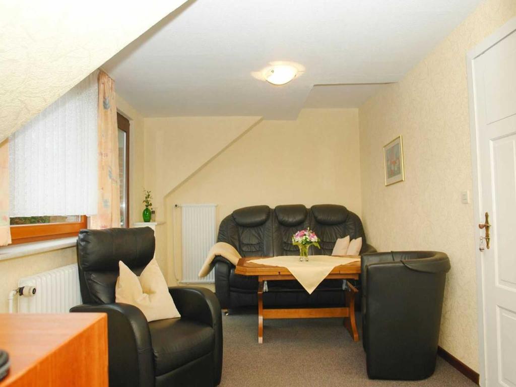 a living room with two chairs and a table at Ferienhof Jens Ferienwohnung 3 in Kronsgaard