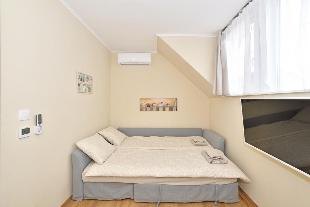 Postel nebo postele na pokoji v ubytování Palmy Apartmanhouse Maglód