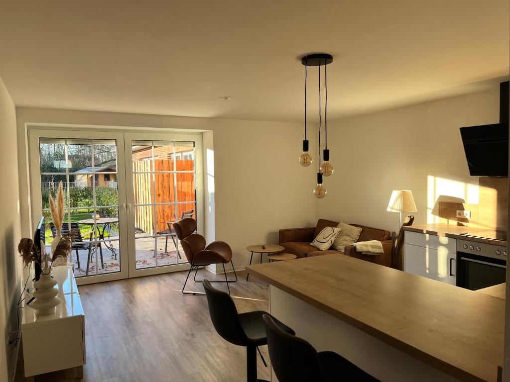 een keuken en een woonkamer met een tafel en stoelen bij Fewo Tenne in Menslage