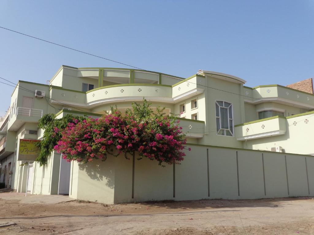 a building with flowers on the side of it at Royal Castle in Rahimyar Khan