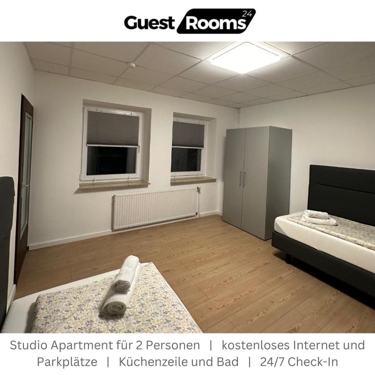 a room with a bedroom with a bed and avertisement at Studio Apartment - GuestRooms24 - Marl in Marl