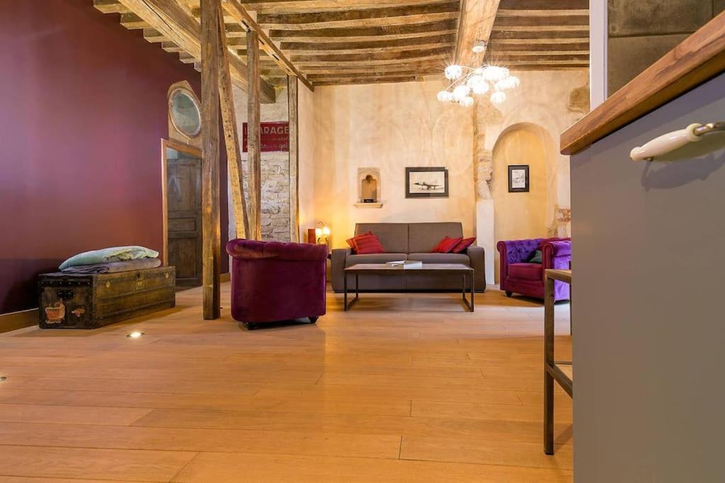 a living room with a couch and two chairs at L'Escale in Dijon