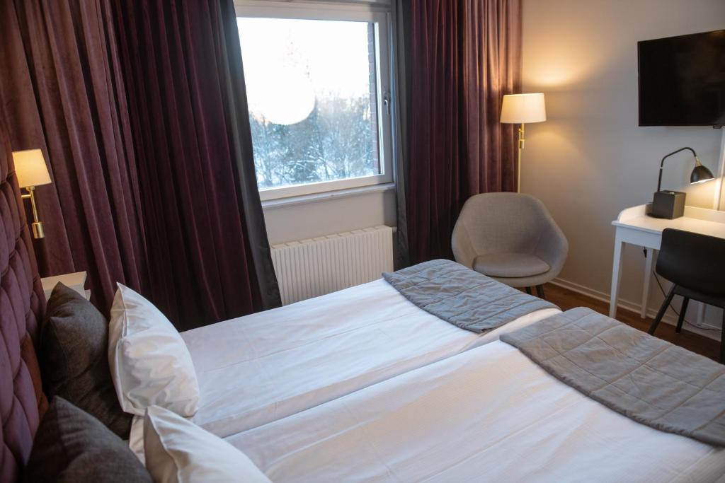 Postel nebo postele na pokoji v ubytování Quality Hotel Galaxen