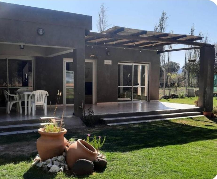 a house with a patio with a fountain in the yard at Departamento con Quincho in Villa Unión