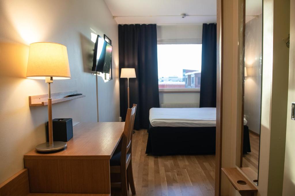 Postel nebo postele na pokoji v ubytování Quality Hotel Galaxen