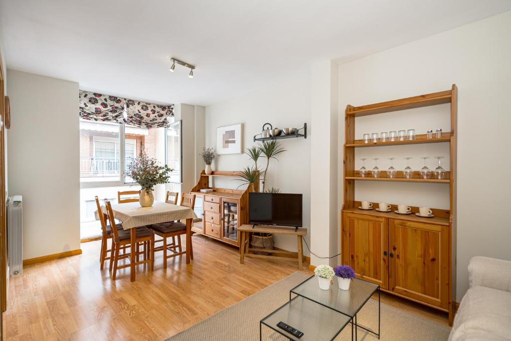 a living room with a couch and a table at 2BR Av América Bernabeu Stadium in Madrid