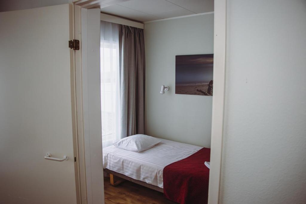 Postel nebo postele na pokoji v ubytování Hotel Promenaadi