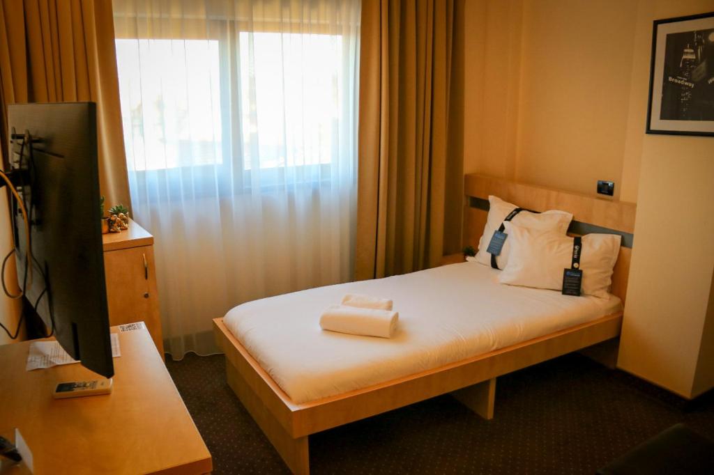 Postel nebo postele na pokoji v ubytování Hotel Clipa