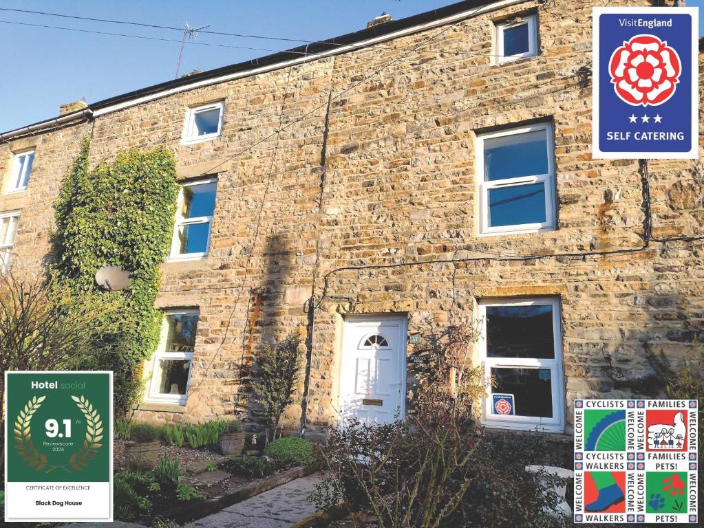 a brick building with signs in front of it at Black Dog House in Bishop Auckland