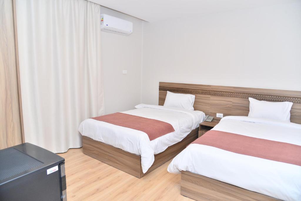 Postel nebo postele na pokoji v ubytování New Lotus Hotel