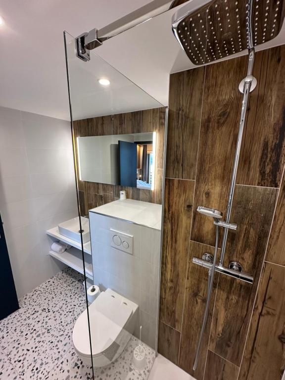 サン・フランソワ・ロンシャンにあるL'Auberge Ensoleilléeのバスルーム(トイレ、ガラス張りのシャワー付)