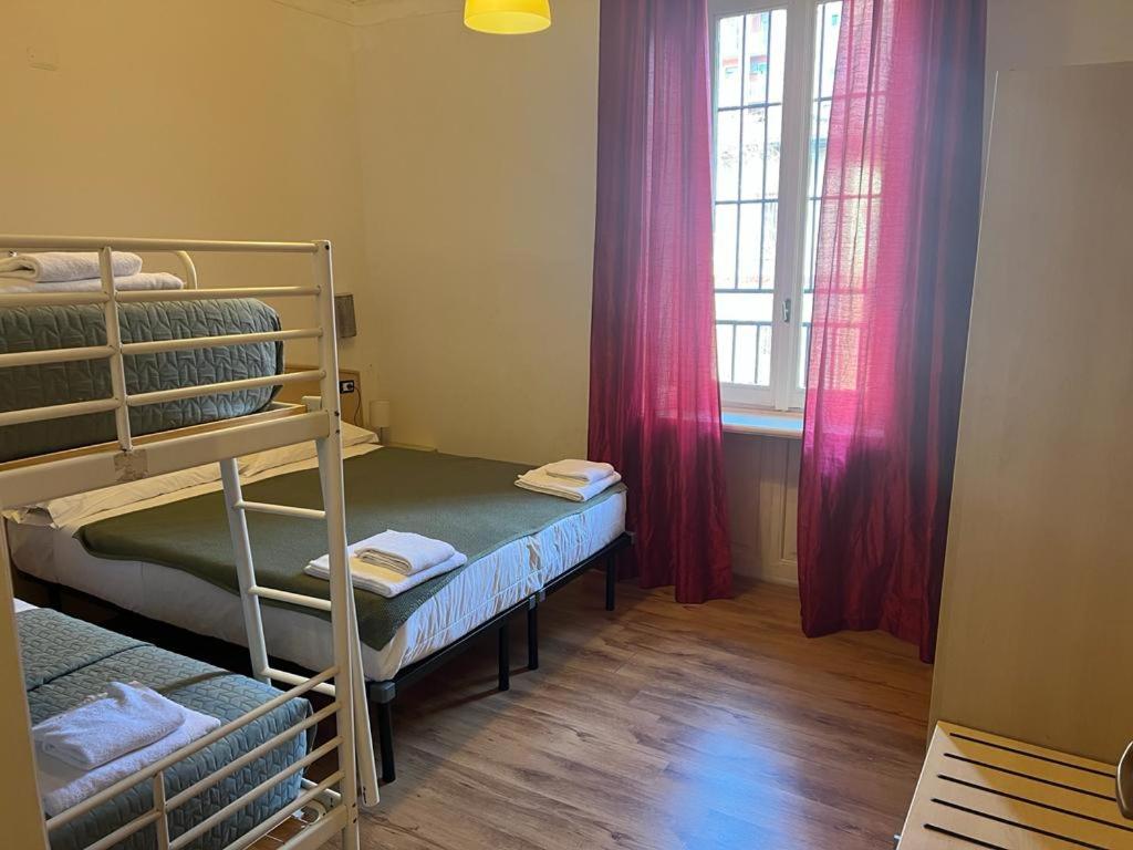 a room with two bunk beds and a window at Ambra Boutique Hotel in Milan