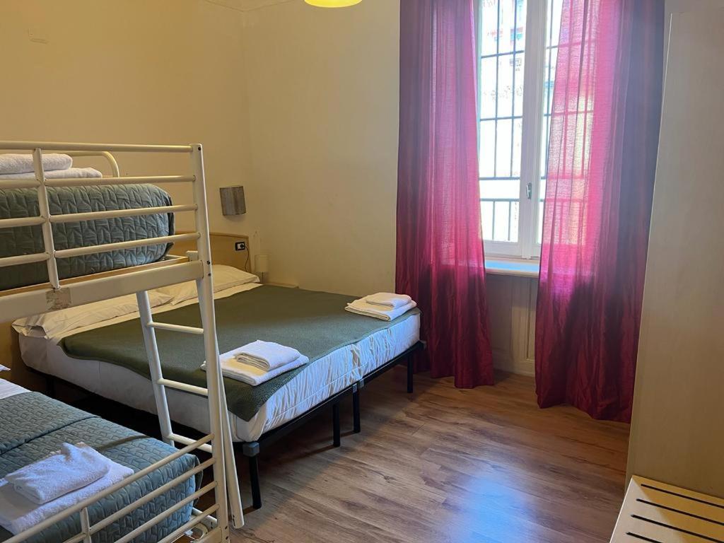 a bedroom with two bunk beds and a window at Ambra Boutique Hotel in Milan