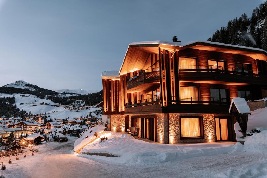 a building on top of a snow covered mountain at Residence Chalet L'Salvan in Selva di Val Gardena