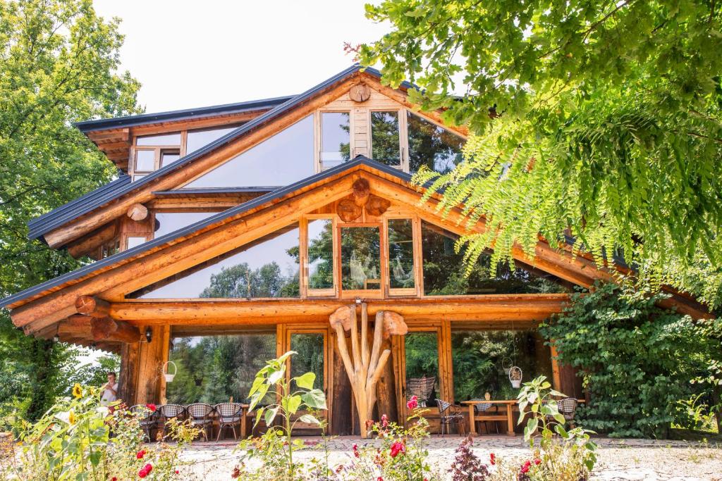 a log cabin with glass windows at Guest House Mala Prica in Živinice